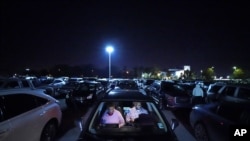 Norman Butler, a first time food bank user, and his girlfriend Cheryl Butler wait overnight in their car, along with others lined up to receive food at a distribution point in Metairie, La. (AP Photo/Gerald Herbert)