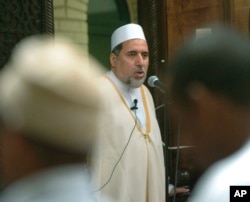 FILE - Imam Shaker Elsayed delivers the sermon at prayers services at the Dar al-Hijra mosque in Falls Church, Va., June 15, 2005.