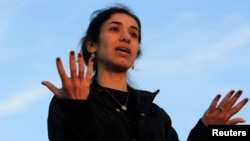 FILE - Nobel Peace Prize laureate, Yazidi activist Nadia Murad, gestures while talking to the people during her visit to Sinjar, Iraq, Dec. 14, 2018.