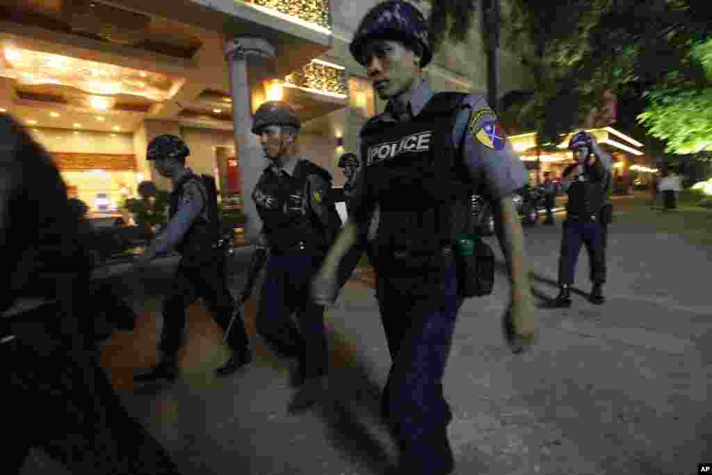 Police patrol near the Traders Hotel after an explosion, Rangoon, Burma, Oct 15, 2013.