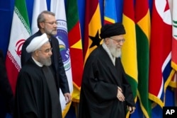 FILE: from left-right, Iran's President Hassan Rouhani, parliament speaker Ali Larijani, and supreme leader Ayatollah Ali Khamenei at a conference to support Palestinian Intifada in Tehran, Iran, Feb. 21, 2017.