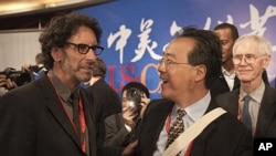 American film director Joel Coen, left, chats with French-born American cellist Ma Yo-Yo after the opening of a forum on "the U.S.-China arts and culture" at National Center for the Performing Arts in Beijing, China, November 17, 2011.