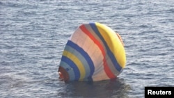 A hot-air balloon drifting on the ocean is seen in the East China Sea near the disputed isles known as Senkaku isles in Japan and Diaoyu islands in China, Jan. 2, 2014.