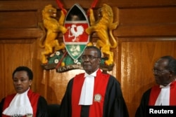 Kenya's Supreme Court judge chief justice David Maraga, center, presides before delivering the ruling making last month's presidential election declared invalid, Sept. 1, 2017.