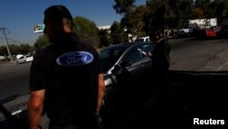 The Ford logo is seen on a t-shirt of an employee in Cuautitlan Izcalli, Mexico, Jan. 4, 2017.