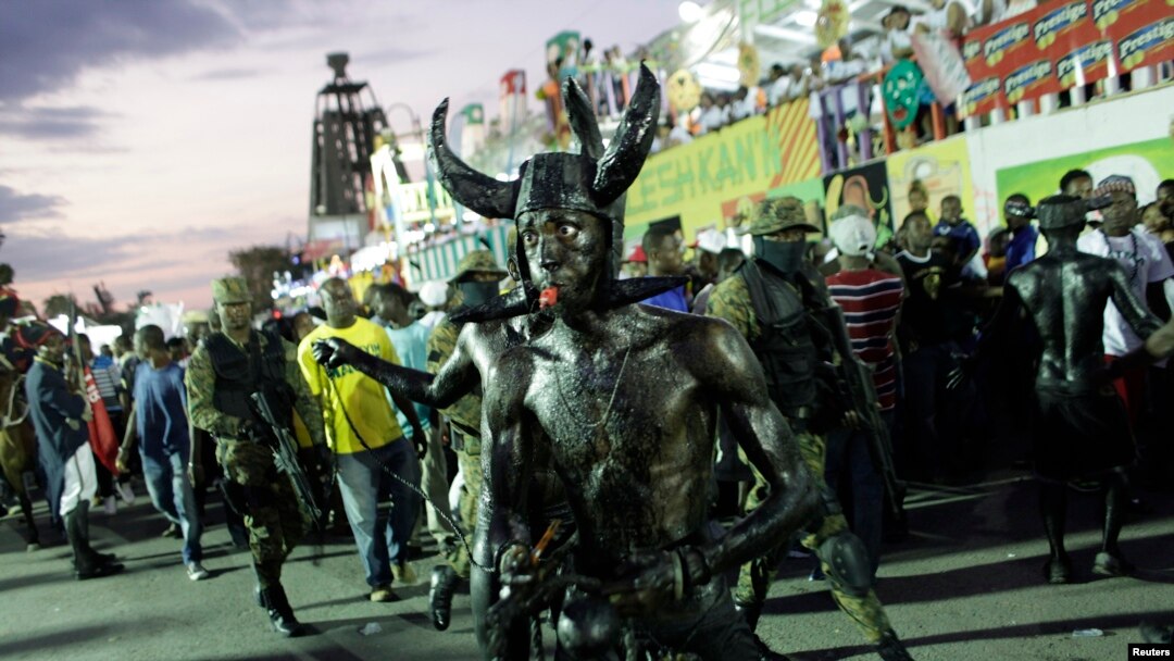 A reveler blows a whistle as he takes part in the National Carnival 2015 annual parade in Port-au-Prince, Feb. 15, 2015.