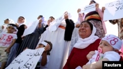 Yazidi women cry as they attend a demonstration at a refugee camp in Kurdish-dominated city of Diyarbakir, Turkey, to mark the second anniversary of what a U.N.-appointed commission of independent war crimes investigators termed a genocide against the Yazidi.