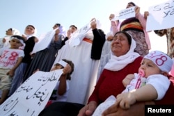 Yazidi women cry as they attend a demonstration at a refugee camp in Diyarbakir, Turkey, to mark the second anniversary of what a U.N.-appointed commission of independent war crimes investigators termed a genocide against the Yazidis in Iraq on Aug. 3. 2016.