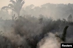 Smoke billows during a fire in an area of the Amazon rainforest near Humaita, Amazonas State, Brazil, Brazil August 14, 2019. Picture Taken August 14, 2019