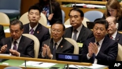 Chinese President Xi Jinping, right, attends the Sustainable Development Summit 2015, Sept. 26, 2015 at United Nations headquarters.