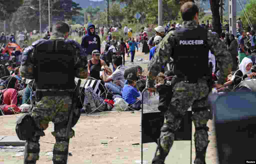 Macedonian special policemen guard the border as more than a thousand immigrants wait at the border between Macedonia and Greece, Aug. 21, 2015.