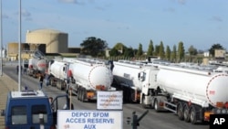 Tanker trucks load fuel at the refinery of French oil giant Total in Donges, 25 October 2010