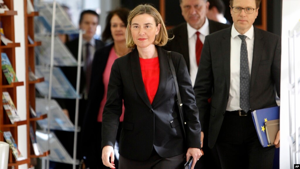 FILE - Federica Mogherini, center, the European Commission's high representative for foreign affairs and security policy, accompanied by EU Ambassador to Macedonia Samuel Zbogar, right, arrives at the European Union office in Skopje, Macedonia, March 2, 2017.