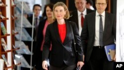 FILE - Federica Mogherini, center, the European Commission's high representative for foreign affairs and security policy, accompanied by EU Ambassador to Macedonia Samuel Zbogar, right, arrives at the European Union office in Skopje, Macedonia, March 2, 2017. 