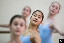 Students perform in a ballet class at the Bolshoi Ballet Academy in Moscow, March 3, 2016. The prestigious academy has 84 foreigners among its 721 students.