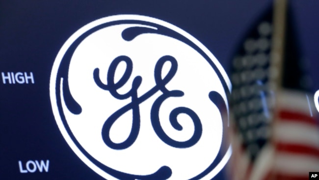 FILE - The General Electric logo appears above a trading post on the floor of the New York Stock Exchange, June 26, 2018. 
