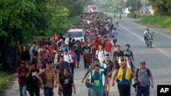 Hundreds of Central American migrants walk on the highway, after crossing the Guatemala – Mexico border, near Ciudad Hidalgo, Mexico, June 5, 2019. 