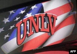 FILE - A University of Las Vegas-Nevada logo is displayed on a scoreboard during a basketball game at the Thomas & Mack Center in Las Vegas.