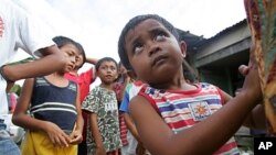 Two-year-old Arfaisal Marsaleh, a stateless child, holds on to his mother in a slum village in Kinarut, in Malaysia's Sabah state on Borneo island (file photo).