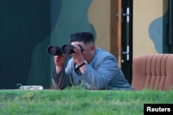 North Korean leader Kim Jong Un watches the test-fire of two short-range ballistic missiles, in this undated picture released by North Korea's Central News Agency, July 26, 2019.