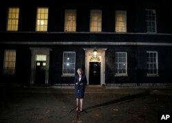 FILE - Britain's Prime Minister Theresa May speaks on the draft Brexit deal outside 10 Downing Street in London, Nov. 14, 2018.