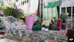 Miniature paper figures of Chapecoense soccer players adorn a memorial at the club’s stadium Conda Arena in Chapeco, Brazil, Dec. 2, 2016.