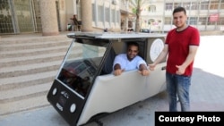 Khaled Bardawil and Jamal al-Meqati pose with their solar-powered car. (Courtesy: Gaza Al-Azhar University)