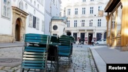 FILE - Abandoned seats of a closed cafe are seen in a street as the Austrian government imposed a fourth national COVID-19 lockdown in Vienna, Austria, Nov. 23, 2021. 