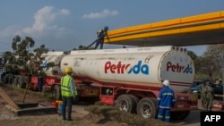 FILE - A tanker offloads fuel at Petroda Filling Station in the capital Lilongwe, Malawi, October 1, 2021.