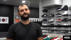 Taylan Akcora, who owns a chain of sports shoe shops, fears that price hikes will be necessary as the value of Turkey's currency falls. (D. Jones/VOA News)