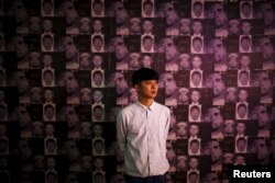 Artist Jirawut Ueasungkomsate poses for a photograph during his exhibition at a gallery in Bangkok, Thailand, March 4, 2016.