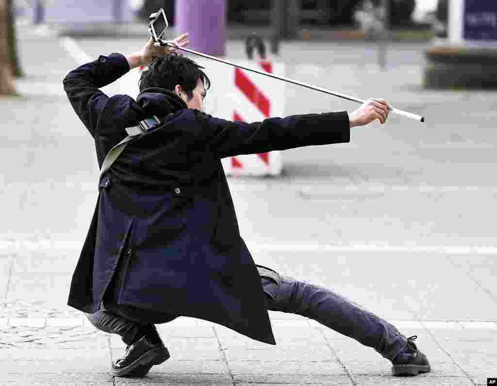 A Chinese tourist shoots a selfie in front of the Old Opera in Frankfurt, Germany.