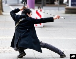 A Chinese tourist gives it all as he shoots a selfie in front of the Old Opera in Frankfurt, Germany, March 2, 2017.