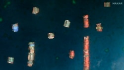 This satellite image provided by Maxar Technologies shows Chinese vessels in the Whitsun Reef located in the disputed South China Sea. Tuesday, March 23, 2021. (©2021 Maxar Technologies via AP)