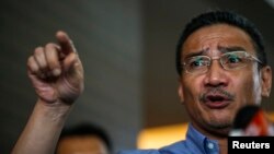 Malaysia's acting Transport Minister Hishammuddin Hussein gestures as he speaks about the search for missing Malaysia Airlines Flight MH370, The Everly Hotel, Putrajaya, March 29, 2014.