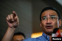 FILE - Malaysia's defense minister Hishammuddin Hussein gestures as he speaks.