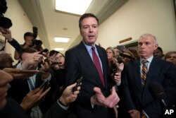 Former FBI Director James Comey, with his attorney, David Kelley, right, speaks to reporters after a day of testimony before the House Judiciary and Oversight committees, on Capitol Hill in Washington, Dec. 7, 2018.