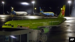 FILE - A plane belonging to Russia's S7 airlines prepares to depart for Moscow's Domodedovo airport from Kyiv, Ukraine, Oct. 24, 2015. Direct flights between the countries were halted Sunday, and Kyiv has refused an offer to talk about resuming them.