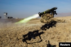 FILE - A U.S. soldier from Dragon Troop of the 3rd Cavalry Regiment fires a Javelin missile system during their first training exercise of the new year near operating base Gamberi in the Laghman province of Afghanistan Jan. 1, 2015.