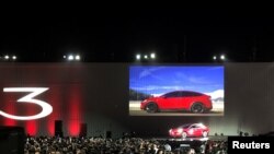 Tesla introduces one of the first Model 3 cars off the factory's production line during an event at the company's facilities in Fremont, California, July 28, 2017.
