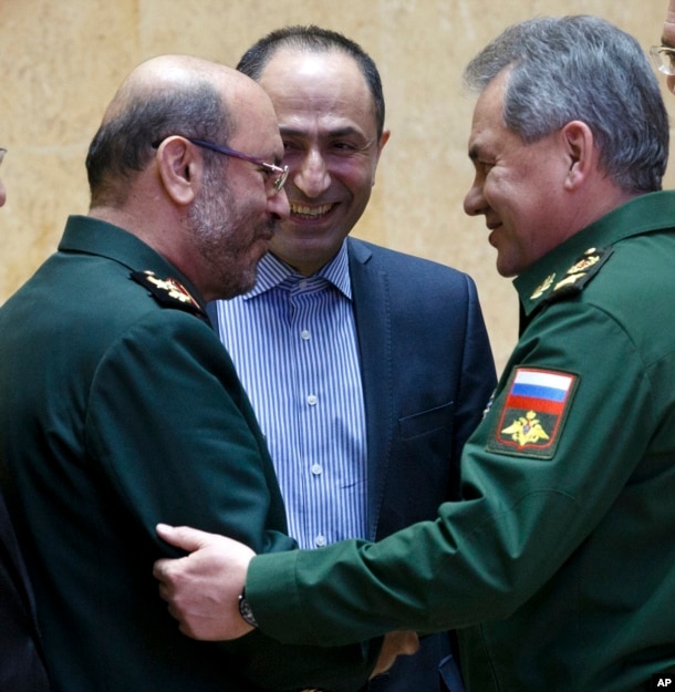 FILE -- Russian Defense Minister Sergei Shoigu, right, and Iranian Defense Minister Hossein Dehghan shake hands during a meeting in Moscow, Russia, Feb. 16, 2016.