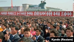 FILE - North Koreans clap during a rally at the Kim Il Sung Square in Pyongyang, April 10, 2014. North Korea held the rally to celebrate the re-election of its leader Kim Jong Un as First Chairman of the ruling National Defense Commission.