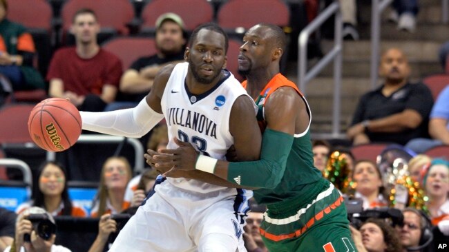 Villanova forward Daniel Ochefu (23) is guarded by Miami center Tonye Jekiri