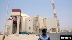 File - A security official stands in front of the Bushehr nuclear reactor, 1,200 km (746 miles) south of Tehran, August 21, 2010. 