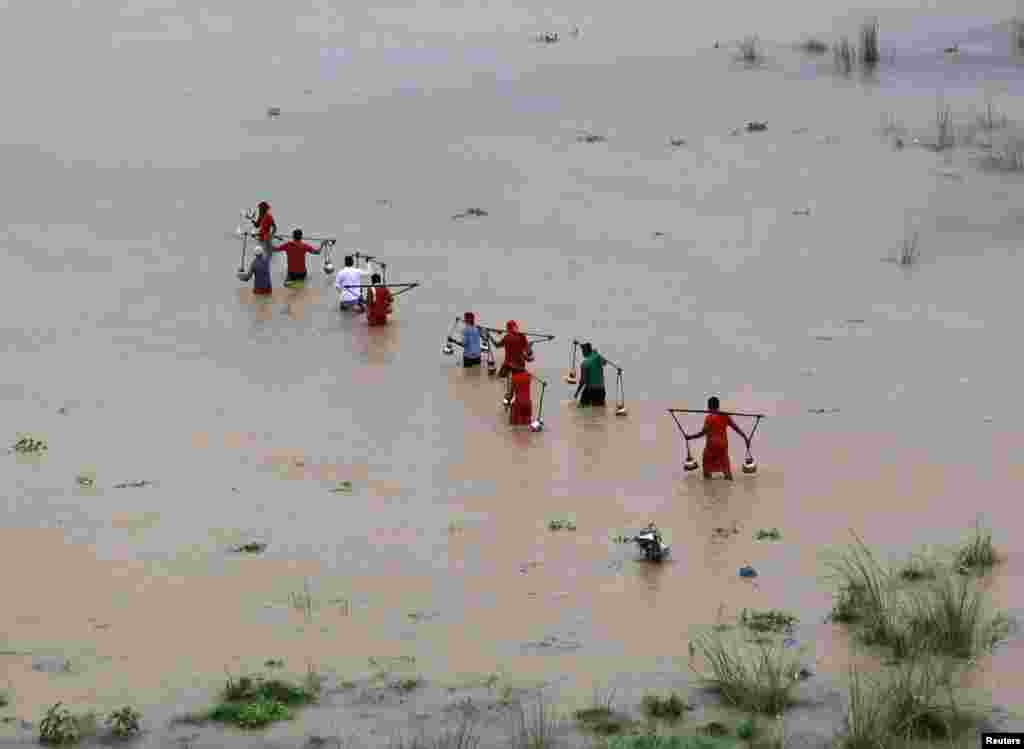 Warga Hindu penganut Dewa Shiwa mengisi ember dengan air dari Sungai Ganga di Allahabad, India utara