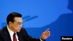 China's Premier Li Keqiang gestures at the end of a news conference following the closing ceremony of China's National People's Congress (NPC) at the Great Hall of the People in Beijing, China, March 16, 2016. 