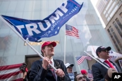 President Donald Trump supporters Tristan Pitera, left, and Jesse Michaelson of Sound Beach, N.Y., take part in a March 4 Trump rally on Fifth Avenue near Trump Tower in New York, March 4, 2017.