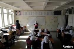 Hadia, 10, a 4th grade primary school student attends a class in Kabul, Afghanistan, Oct. 26, 2021. The hardline Islamist Taliban movement has allowed all boys and younger girls back to class, but has not let girls attend secondary school.