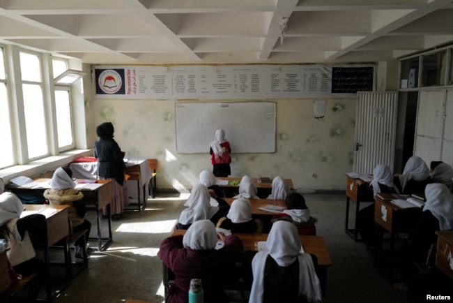 Hadia, 10, a 4th grade primary school student attends a class in Kabul, Afghanistan, Oct. 26, 2021. The hardline Islamist Taliban movement has allowed all boys and younger girls back to class, but has not let girls attend secondary school.