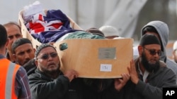 Mourners carry a victim of the March 15 mosque shootings for burial at the Memorial Park Cemetery in Christchurch, New Zealand, March 22, 2019. A mass funeral was held to bury 26 of the victims at the cemetery.